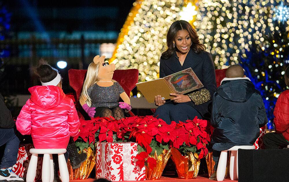 First lady Michelle Obama with Miss Piggy, left, read 'Twas the Night Before Christmas for children on stage during the National Christmas Tree Lighting ceremony at the Ellipse in Washington