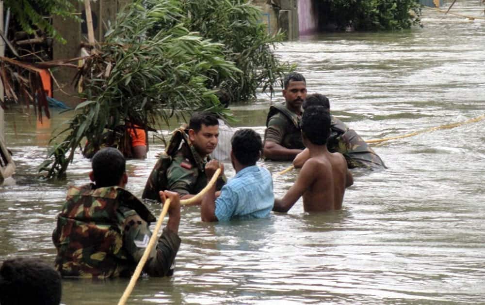 Army personnel using a rope to rescue people in a flooded locality in Chennai.