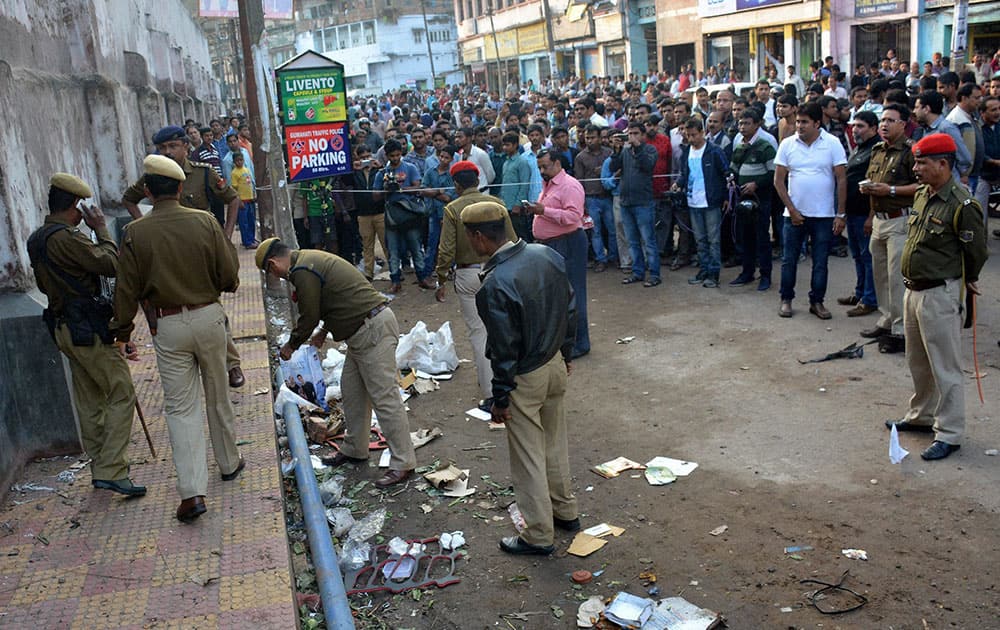 Police personnel investigating at the spot after a bomb blast took place at Jail Road, Fancy Bazar in Guwahati.