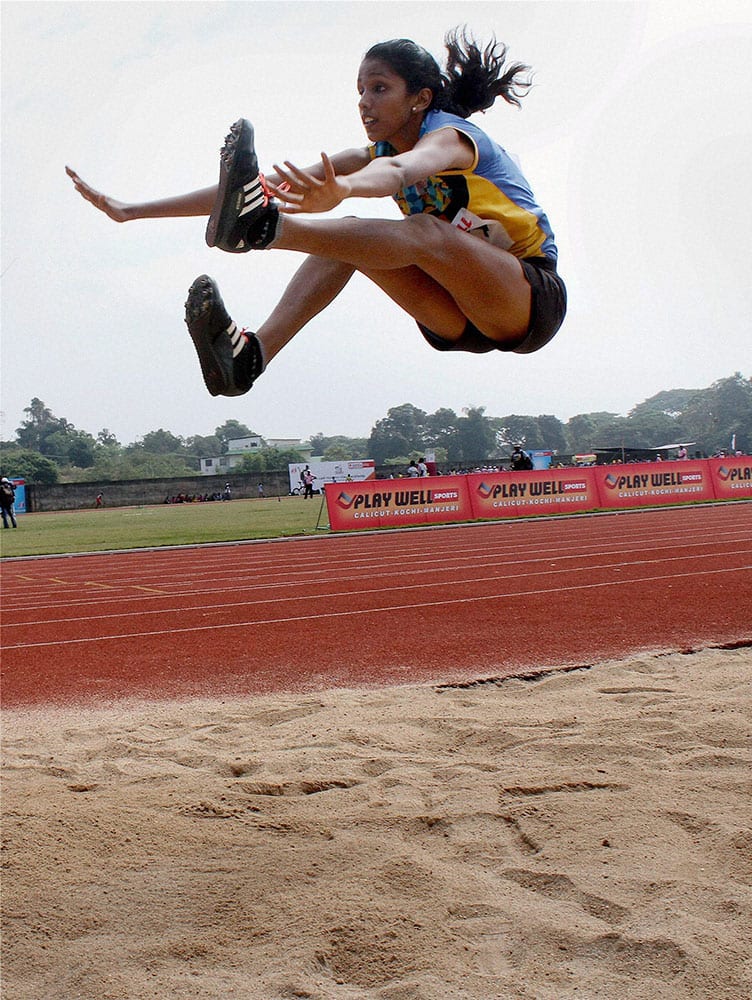 Anfi Lukose jumps to win gold at the Kerala State School Athletic Meet in Kozhikode.