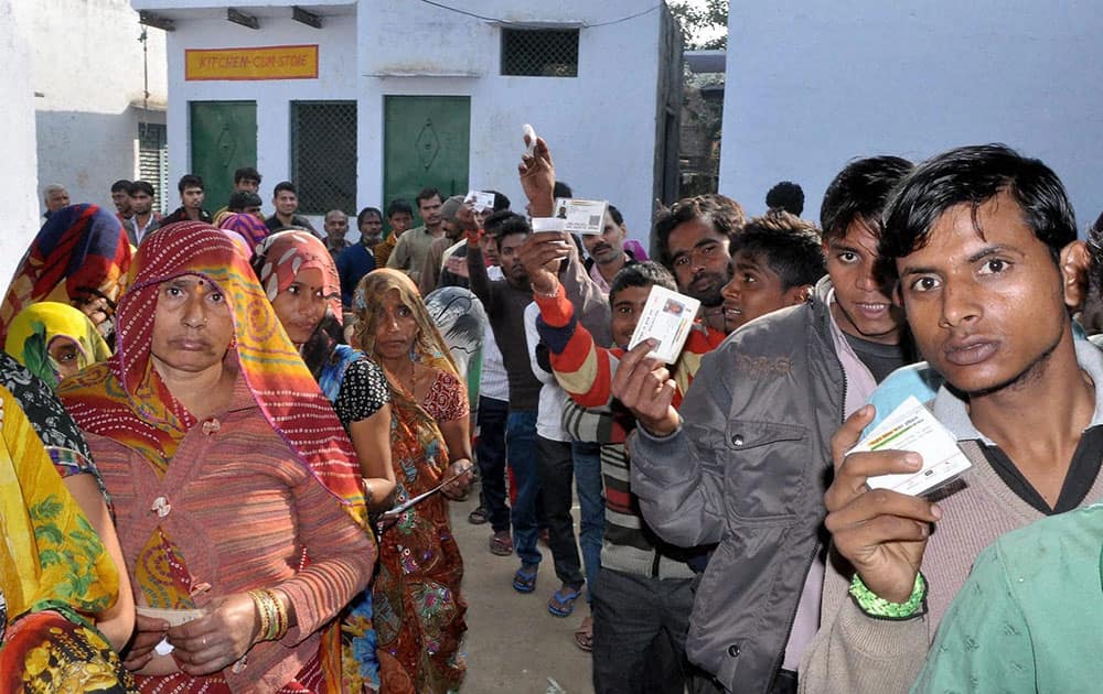 People wait to cast votes for Gram Panchayat elections in Mathura.