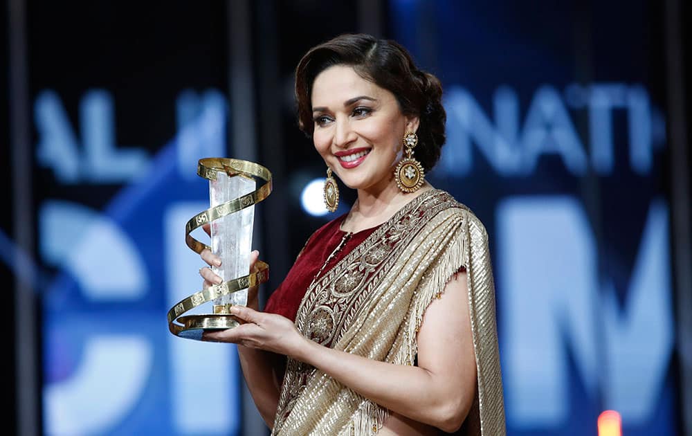 actress Madhuri Dixit holds her award for her contribution to acting, during the 15th Marrakech International Film Festival in Marrakech, Morocco.