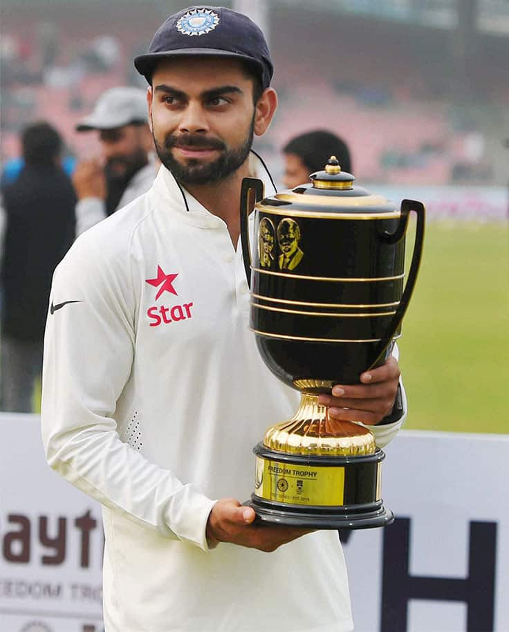 Indian cricket captain Virat Kohli poses with winning trophy after defeating South Africa at Ferozshah Kotla Stadium in New Delhi.