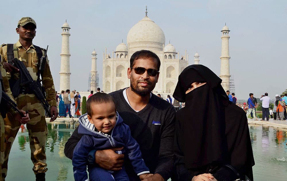 Cricketer Yusuf Pathan with his family poses in front of Taj Mahal in Agra.