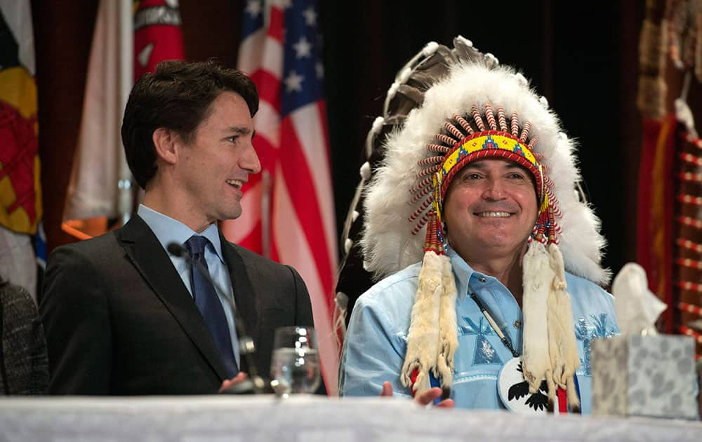 Canadas Prime Minister Justin Trudeau and AFN National Chief Perry Bellegarde laugh as they talk before the beginning of the Assembly of First Nations Special Chiefs Assembly in Gatineau, Quebec.