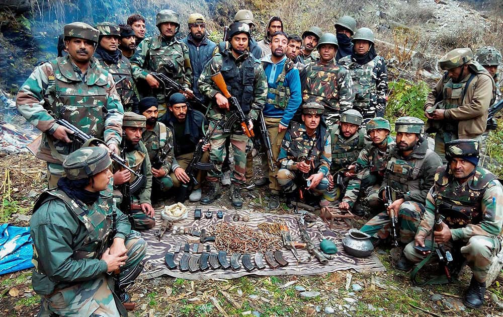 Army Jawans with the arms and ammunition recovered from the possession of militants after a joint team of Delta Force and police busted a militant hideout in Doda district of Jammu and Kashmir.