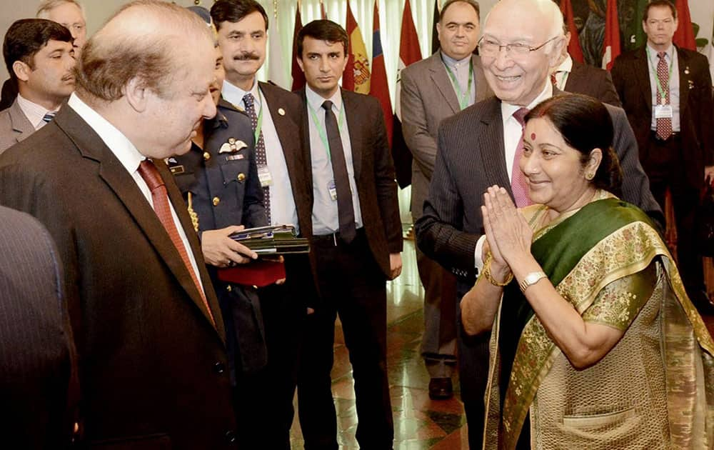 External Affairs Minister Sushma Swaraj greets Pakistan Prime Minister Nawaz Sharif as Pakistans Foreign Affairs Adviser Sartaj Aziz looks on at the Ministerial Conference of Heart of Asia - Istanbul Process in Islamabad.