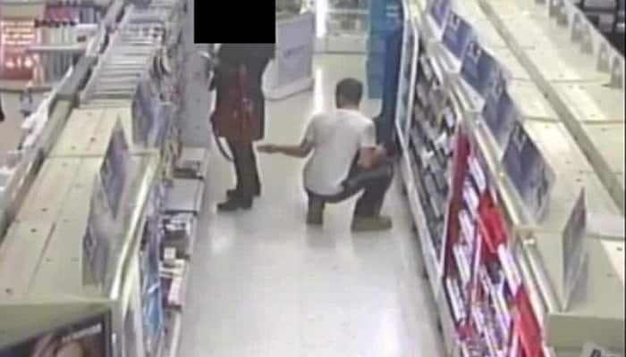 Shocking! Man kneels on ground, takes photos up a woman&#039;s skirt with phone