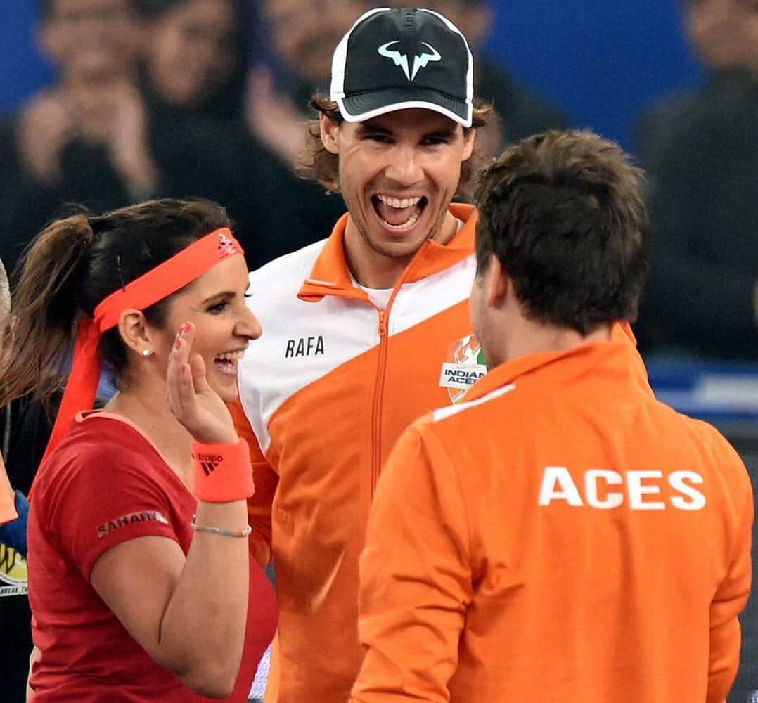 Indian Aces Sania Mirza and Rohan Bopanna celebrate with Rafael Nadal after winning mixed doubles match against UAE Royals by 6-4 during the International Premier Tennis League (IPTL) at IG Stadium in New Delhi.