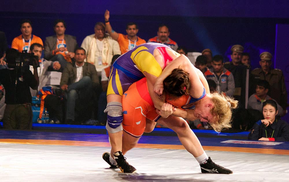 Oksana Herhel of Haryana Hammers fights with Elif Jale Yesilirmak of Delhi Veer during the Pro wrestling league 2015 in New Delhi.