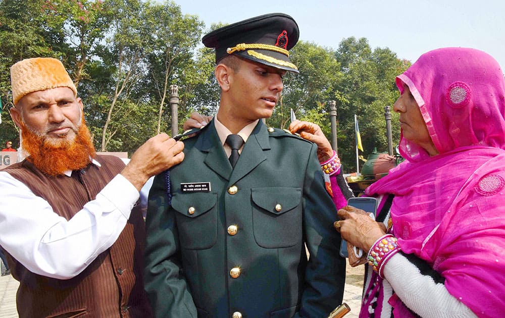 Parents piping their son at the Passing Out Parade at Officers Training Academy in Gaya.