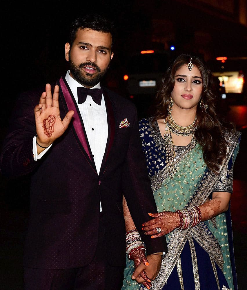 Newly wed couple cricketer Rohit Sharma and Ritika Sajdeh pose for a photo at their wedding venue in Mumbai.