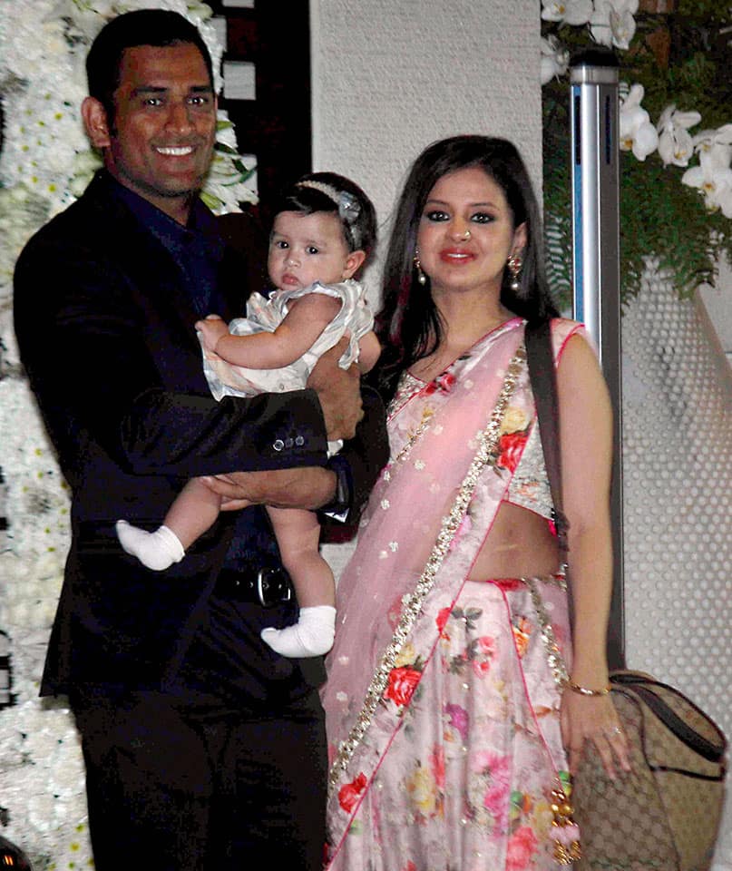 Cricketer Mahendra Singh Dhoni along with his wife Sakshi Dhoni and daughter Ziva during the wedding celebrations for cricketers Harbhajan Singh and Rohit Sharma.