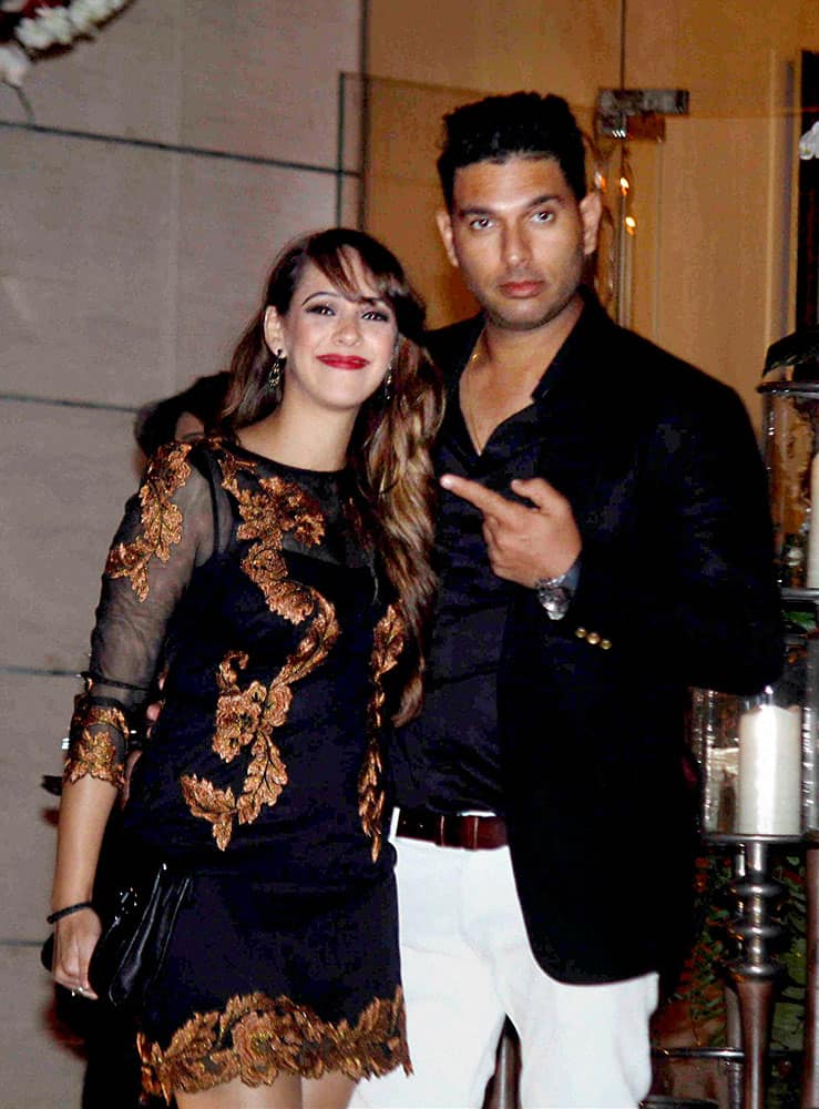 Cricketer Yuvraj Singh and Hazel Keech during a party to celebrate the recent weddings of Harbhajan Singh and Rohit Sharma.