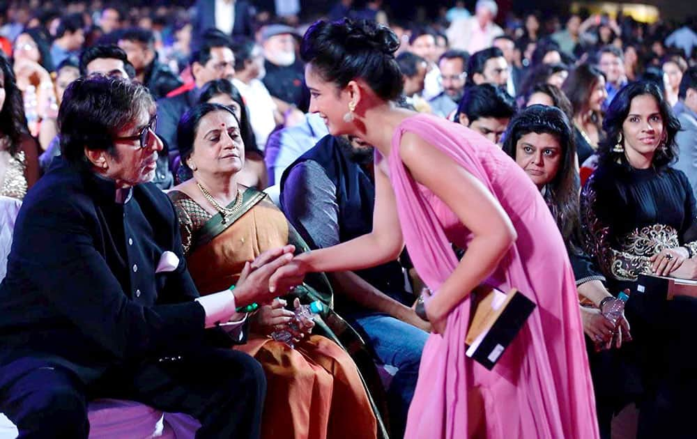 Actor Amitabh Bachchan is greeted by Akshara Haasan during the Big Star Entertainment Awards event in Mumbai.