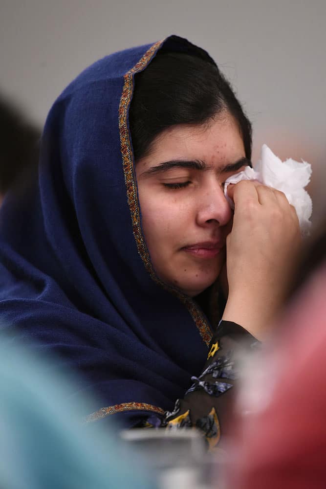 Nobel Prize winner Malala Yousafzai wipes away tears as she listens to eye witness accounts of the Taliban attack on the Army Public School in Peshawar, Pakistan, which took place on Dec. 16, 2014, and killed 150 people, as she attends the Poppies for Peace in Peshawar event in Birmingham, central England.