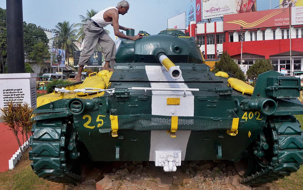 A worker cleaning a tank, captured from the Pakistani army by Indian soldiers in the Bangladesh war of 1971, at Chowmuhani Post office on the eve of Victory Day, in Agartala.