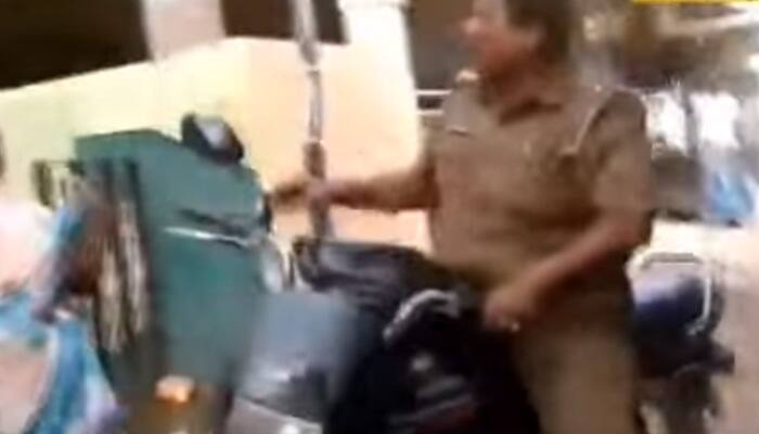 In flood-hit Chennai, cop snatches away relief material from old woman- Watch