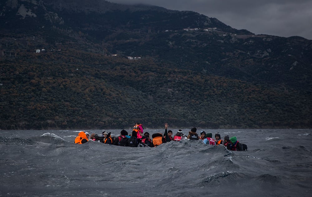 Refugees and migrants on a dinghy approaching the Greek island of Lesbos. According to the International Organization for Migration, more than 920,000 people have entered the EU so far this year.