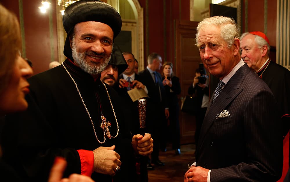 Britain's Prince Charles talks to Archbishop Athanasius Toma Dawod, left, of the Syrian Orthodox Church during a reception for various religious leaders in London.