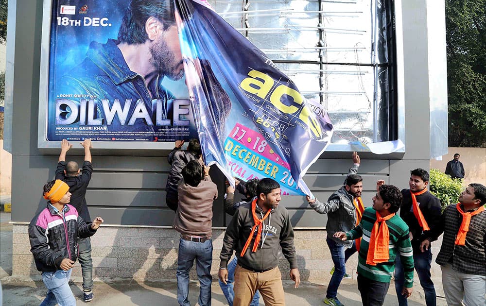 Hindu Sena activists tearing a poster of actor Shaharukh Khans film Dilwale during a protest against its screening.