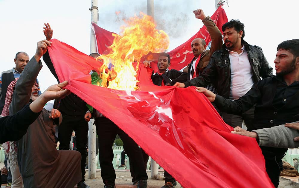 Protesters burn a Turkish flag during a demonstration calling for the withdrawal of Turkish troops from northern Iraq, in Basra.