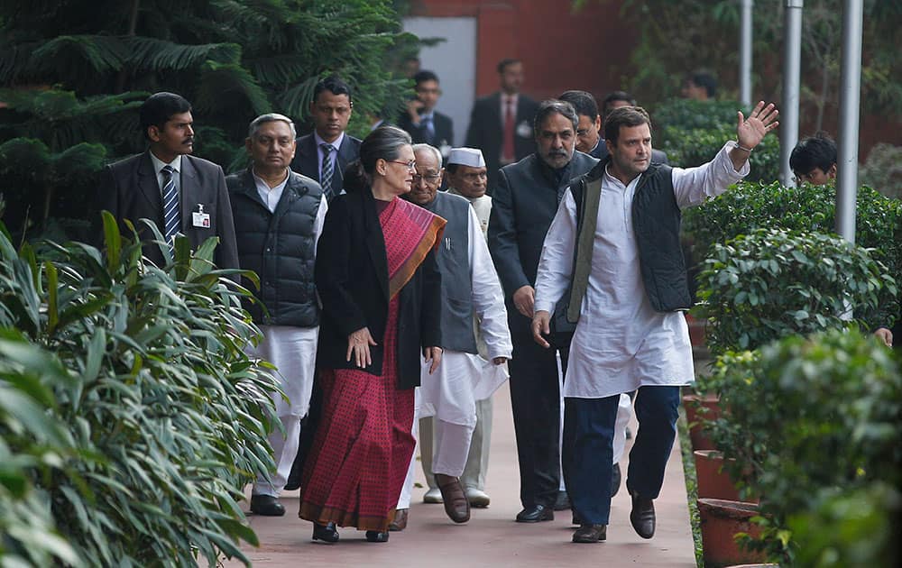 Congress Party president Sonia Gandhi, front center and her son and party Vice President Rahul Gandhi, right, arrive at party headquarters to brief the media after returning from court in connection with a corruption accusation in New Delhi.