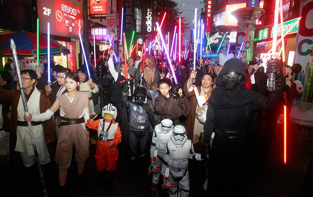 Fans dressed as Star Wars characters parade outside a movie theater showing 'Star Wars: The Force Awakens', in Taipei, Taiwan.