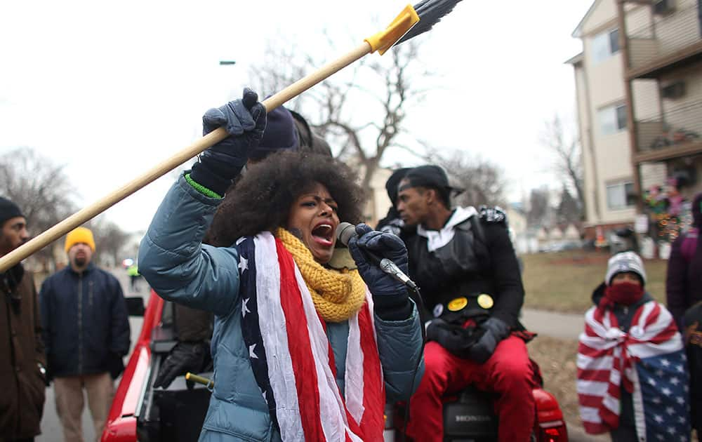 Jayanthi Kyle lead speaks to the crowd as protesters march to demand the prosecution of police involved in the shooting death of a black man last month in Minneapolis. 