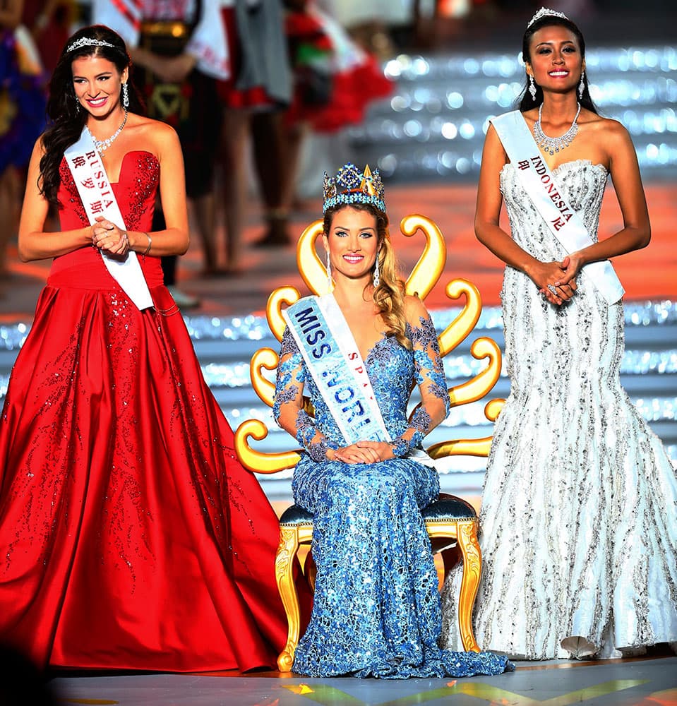 Miss World Mireia Lalaguna Royo from Spain, centre, Sofia Nikitchuk from Russia, left, the runner-up, and Maria Harfanti from Indonesia, right, the second runner-up celebrate at the end of the 2015 Miss World Grand Final in Sanya in south China's Hainan province.