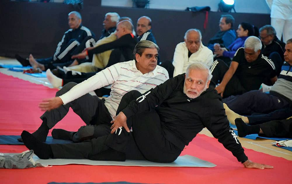 Prime Minister Narendra Modi performs yoga during a yoga session along with over 200 top police officers at a annual conference in Rann of Kutch, Gujarat.
