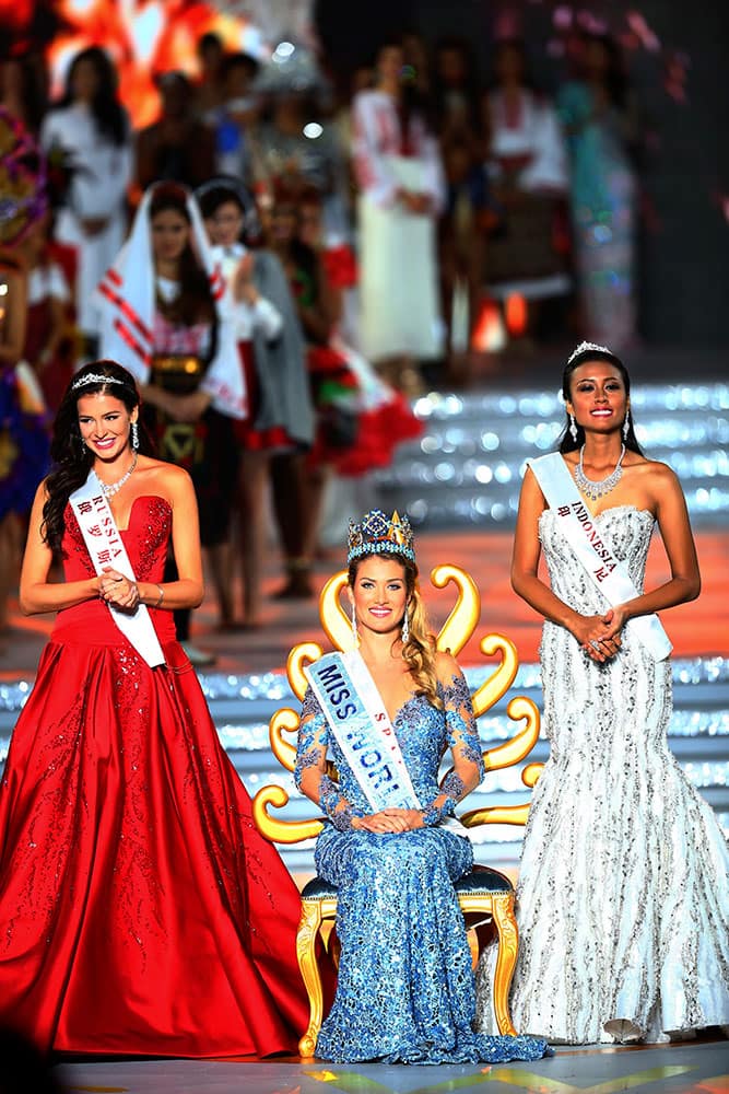 Miss World Mireia Lalaguna Royo from Spain, centre, Sofia Nikitchuk from Russia, left, the runner-up, and Maria Harfanti from Indonesia, right, the second runner-up celebrate at the end of the 2015 Miss World Grand Final in Sanya in south China's Hainan province.