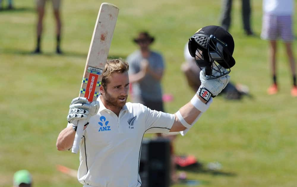 New Zealand’s Kane Williamson salutes his century against Sri Lanka on the fourth day of the second international cricket test in Hamilton, New Zealand.