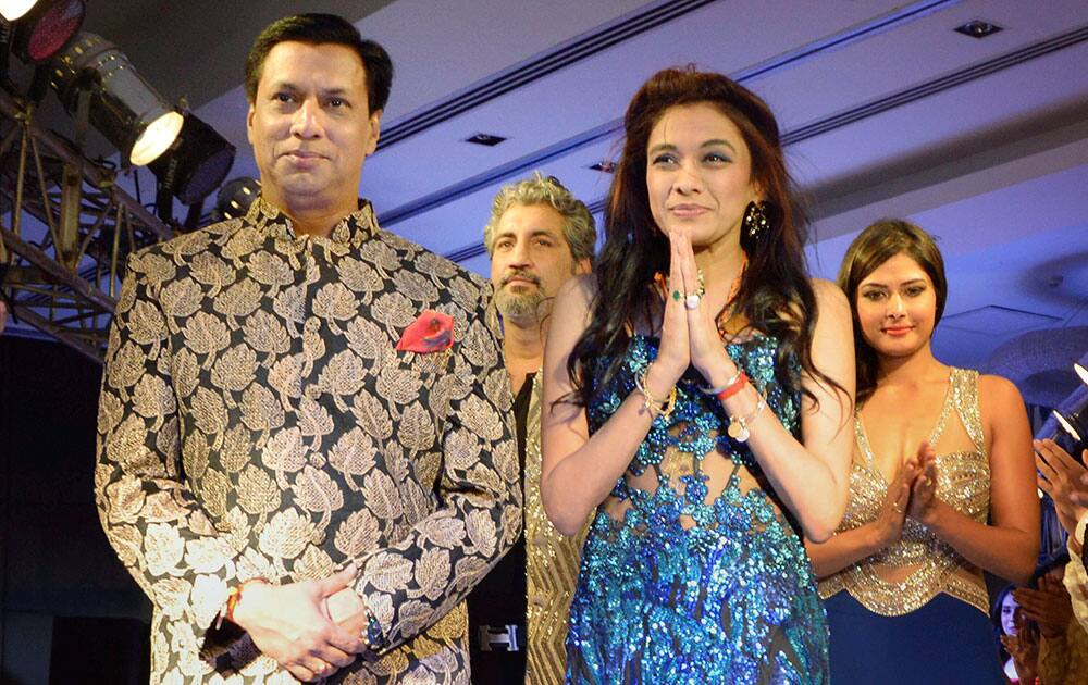 Bollywood director Madhur Bhandarkar walks the ramp with designer Sanjana Jon during Gurgaon Fashion Week in Gurgaon.