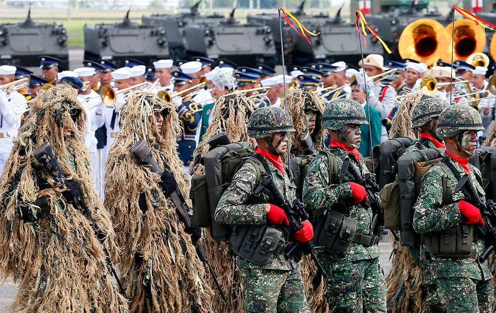 Philippine Special Forces march past the grandstand during the 80th celebration of the founding of the Armed Forces of the Philippines at Clark Air Base in Pampanga province, north of Manila, Philippines.