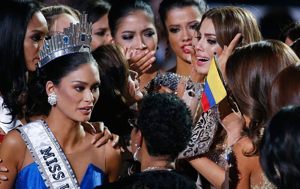 Other contestants comfort Miss Colombia Ariadna Gutierrez, top right, after she was incorrectly crowned Miss Universe at the Miss Universe pageant  in Las Vegas. 