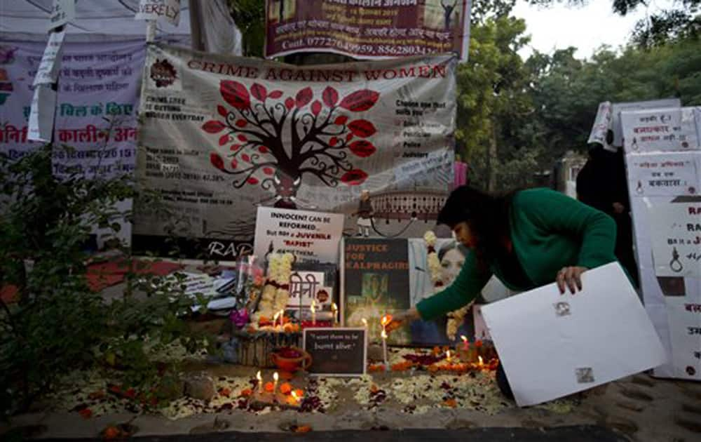 A protester lights candles at a temporary shrine dedicated to the victim of a fatal gang-rape of 2012 during a protest against the release of one of the convicts.
