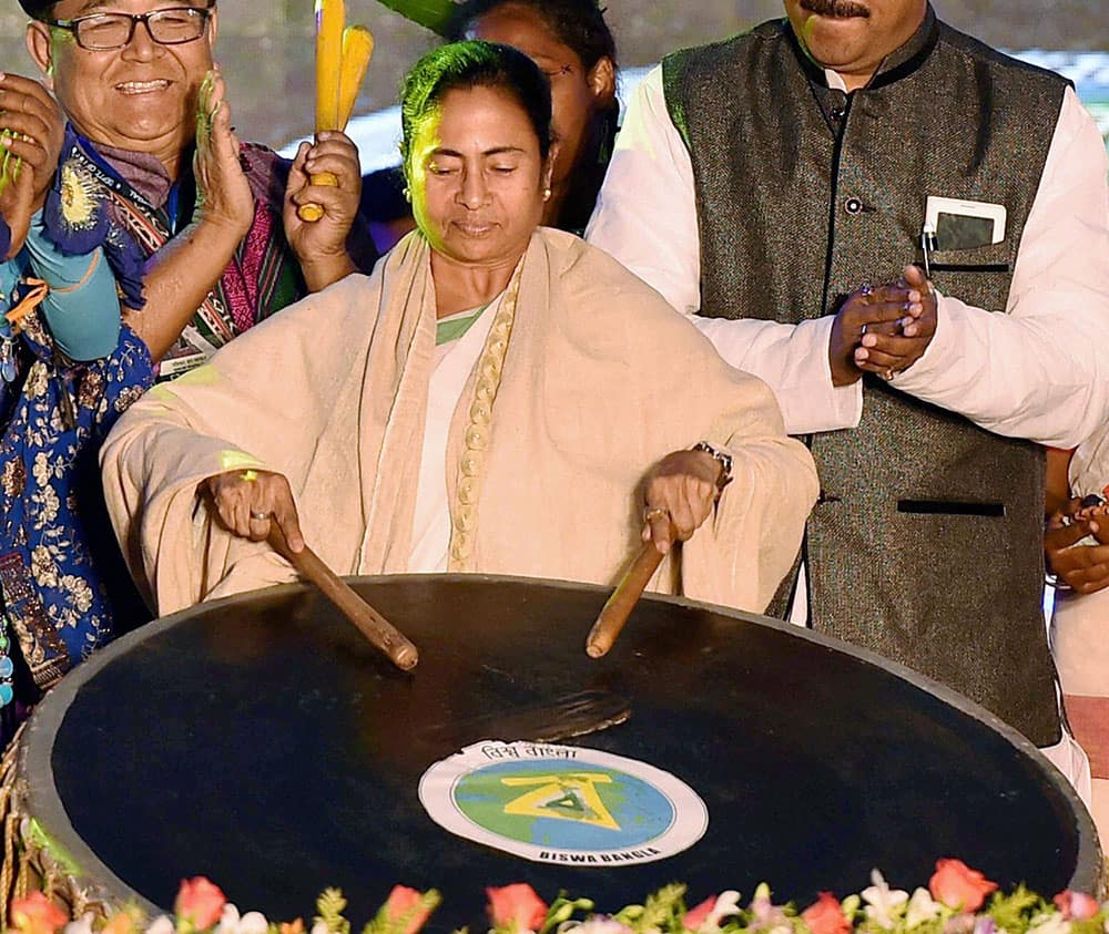 West Bengal Chief Minister Mamata Banerjee beating a drum during inauguration of Biswabangla Loksanskriti Utsav on a floating stage in kolkata.
