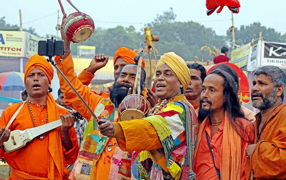 Rural folk singers (bouls) take a selfie on their arrival to participate in the 121st Santiniketan Poush Mela at Santiniketan in Birbhum district of West Bengal.