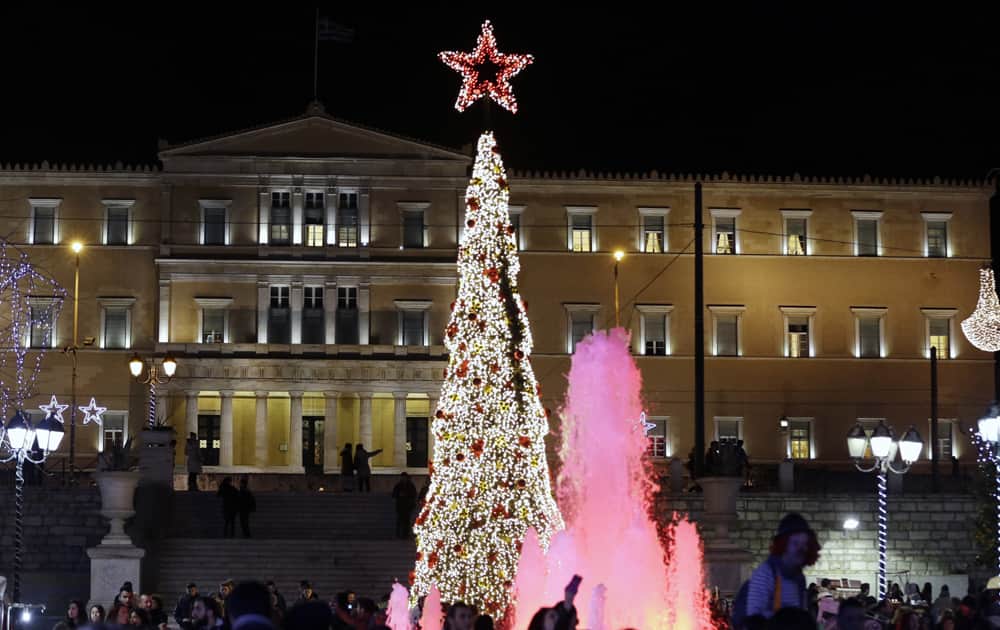 The Greek Parliament behind the Christmas tree at the Athens' main Syntagma square. Greeks are set to celebrate their sixth Christmas of austerity, as the country braces for more cutbacks demanded by international creditors in return for Greece's third bailout deal, signed in the summer. 