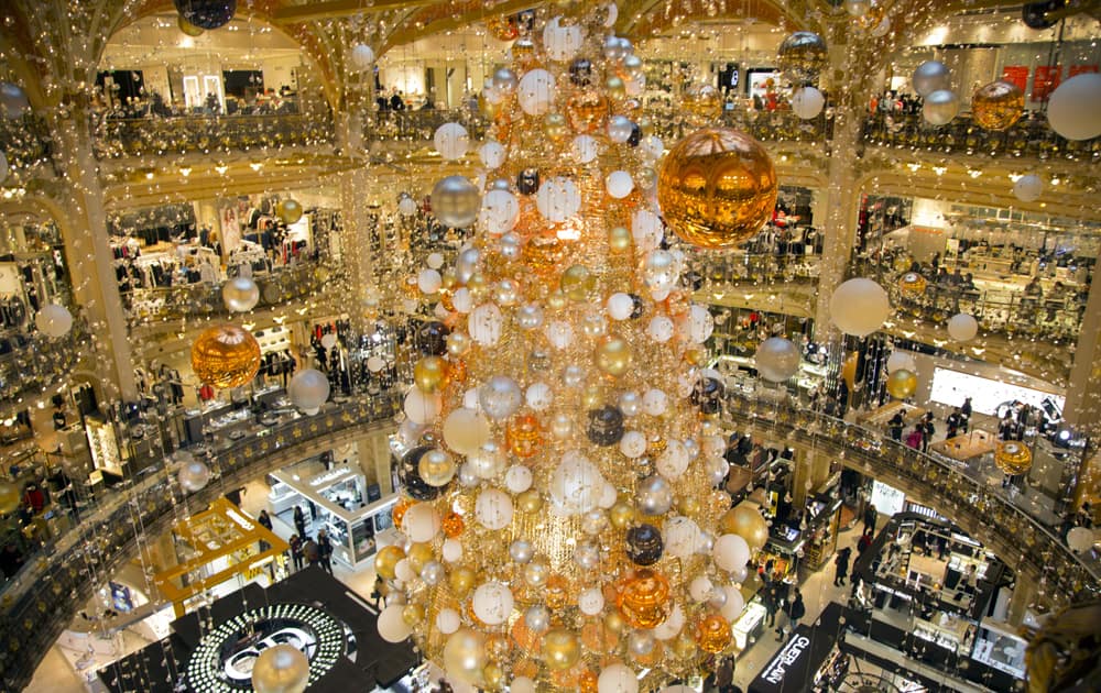 A CHRISTMAS TREE IS ERECTED AT THE CENTER OF A PARIS DEPARTMENT STORE. THE DECORATIONS ARE TRADITIONALLY PUT UP LATE NOVEMBER EACH YEAR FOR CHRISTMAS.

