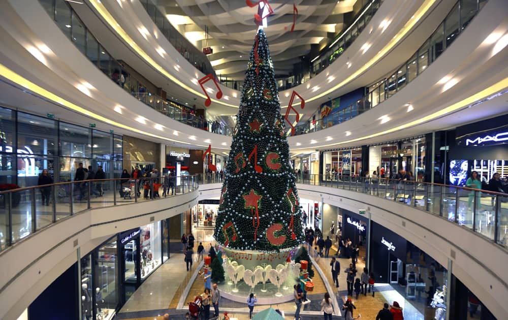 PEOPLE PASS BY A GIANT CHRISTMAS TREE DISPLAYED TO CELEBRATE THE UPCOMING HOLIDAY SEASON AT A SHOPPING MALL IN BEIRUT, LEBANON.
