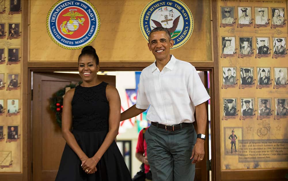First lady Michelle Obama, left, and President Barack Obama arrive for an event to thank service members and their families at Marine Corp Base Hawaii.