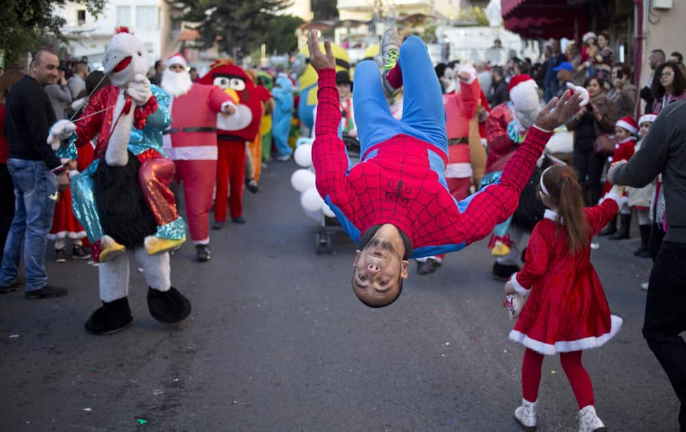 Israeli Arab Christians perform at the annual Christmas parade in in the northern Israeli city of Nazareth, Israel, 