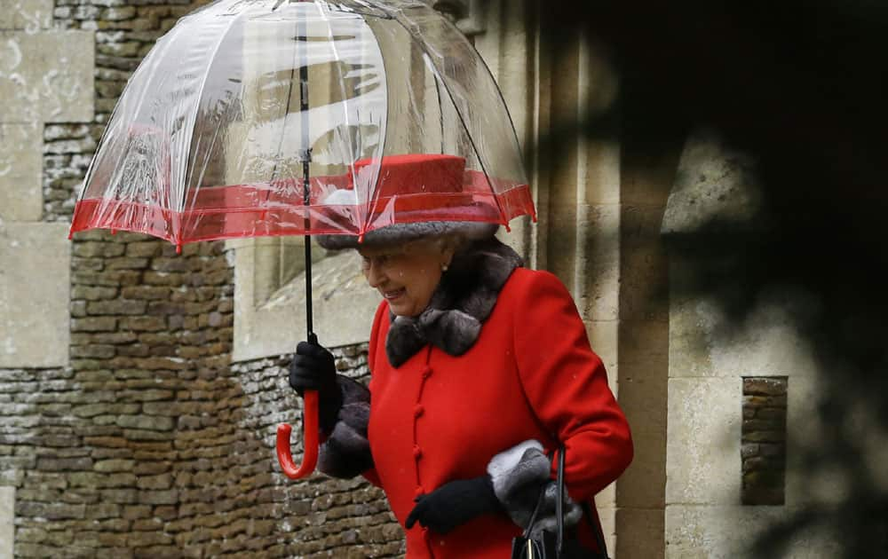 Britain's Queen Elizabeth II shelters under an umbrella as she leaves, after attending the British royal family's traditional Christmas Day church service at St. Mary Magdalene Church in Sandringham, England.
