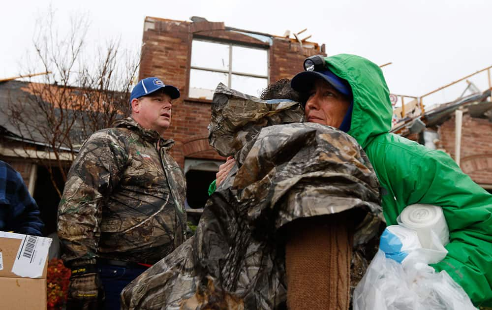 Cheryl Turek, of Nevada, Texas, right, hugs Evelyn Lindstrom in front of Lindstrom's destroyed home in Copeville, Texas, after heavy rain, high winds and tornados swept through North Texas.