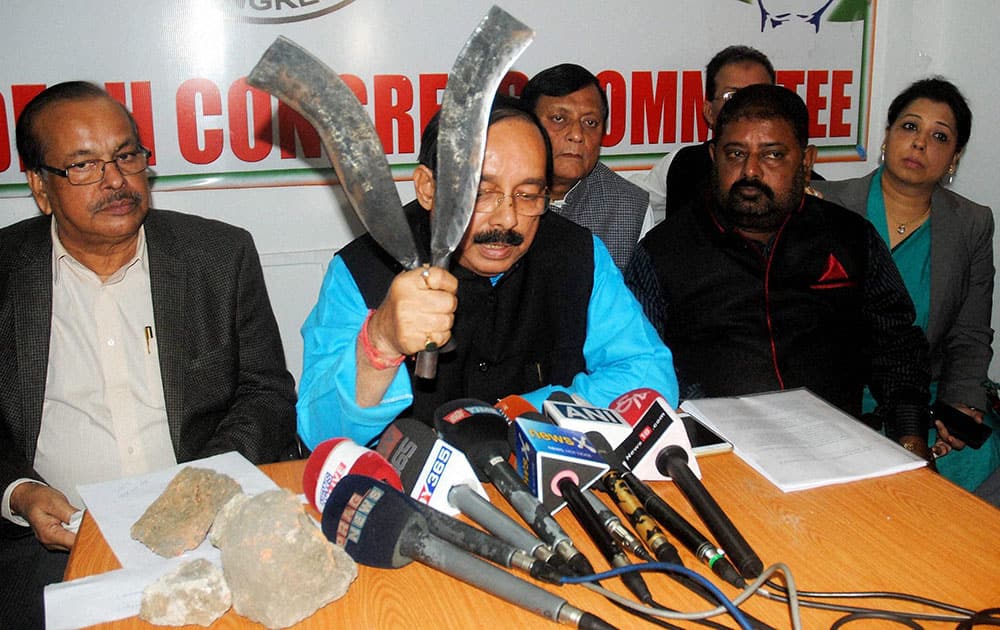 Assam Pradesh Congress Committee (APCC) President Anjan Dutta displays stones and sharp weapons allegedly used by BJP activists during their attack on Congress party office Rajiv Bhavan, at a press conference in Guwahati.