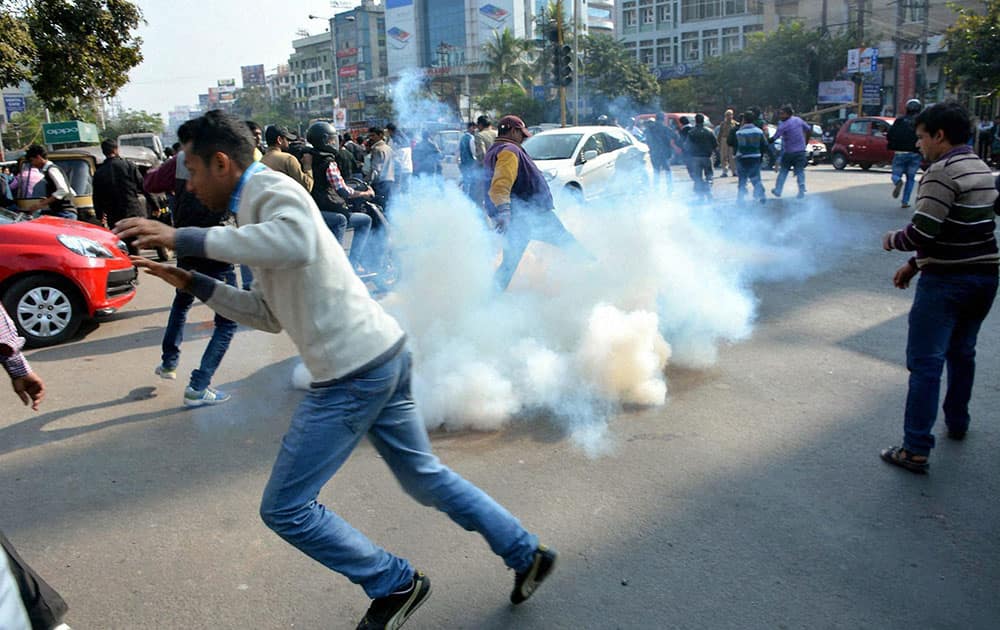 Police use teargas to disperse BJP activists who were protesting at Rajiv Bhawan against former Congress Minister and senior leader Nilomoni Sen Dekas remarks on Union HRD Minister Smriti Irani in Guwahati.
