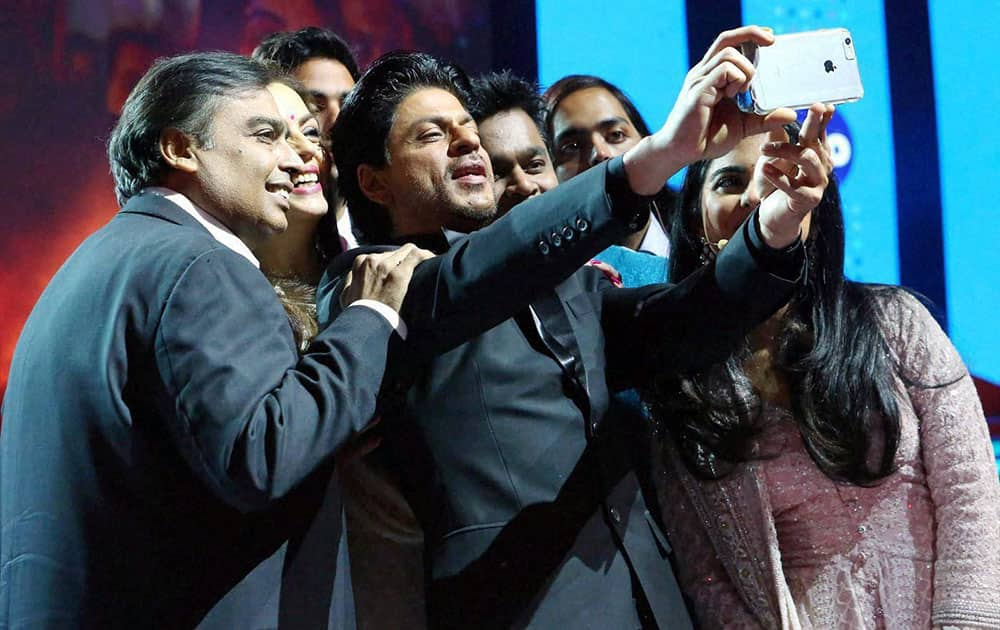 Actor Shahrukh Khan takes a selfie with RIL Chairman Mukesh Ambani and his family during the launch of Reliance Jio 4G services in Mumbai.