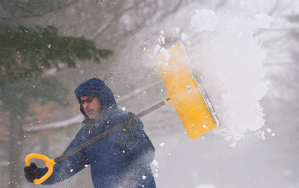 Mike Stefanakis shovels his driveway in Saint Lazare, west of Montreal.